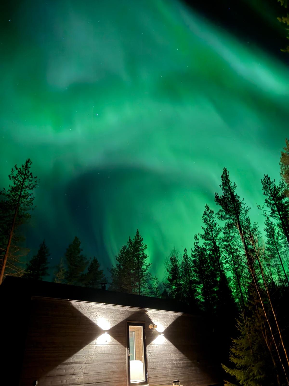 A ring of northern lights above the villa roof