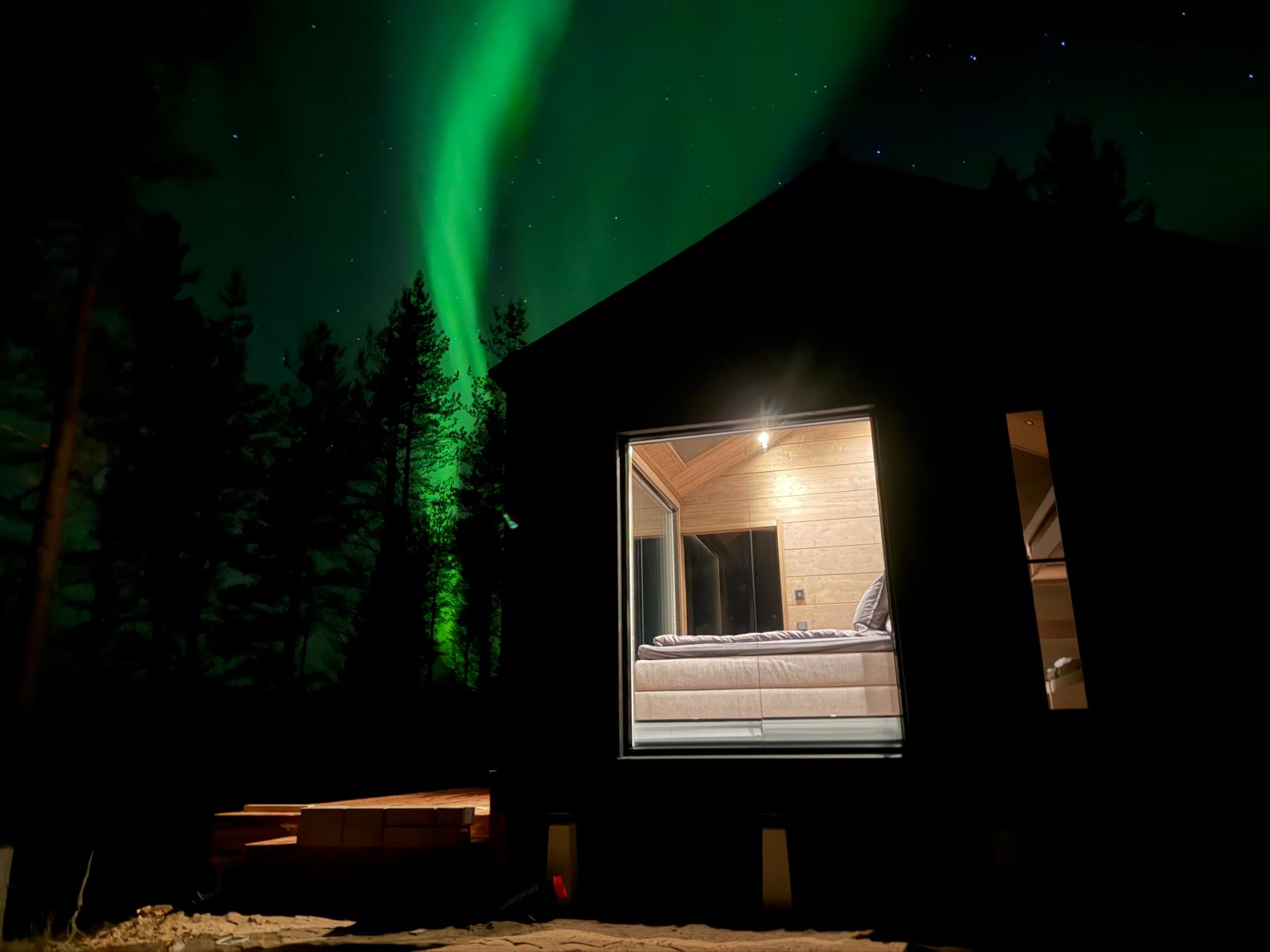 Northern lights rising behind the villa