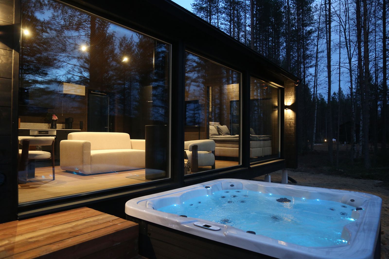 The hot tub glowing in front of the villa in the evening